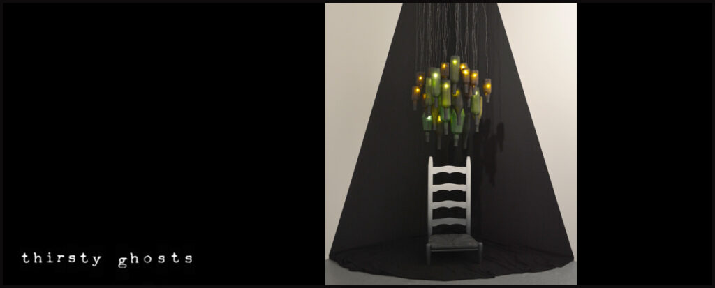 Image of a sculpture with its legs cut off and many hanging bottles with lights inside